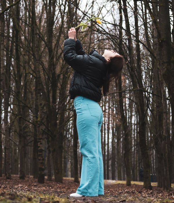 Woman holding a serene yoga pose in a calm, minimalist environment.